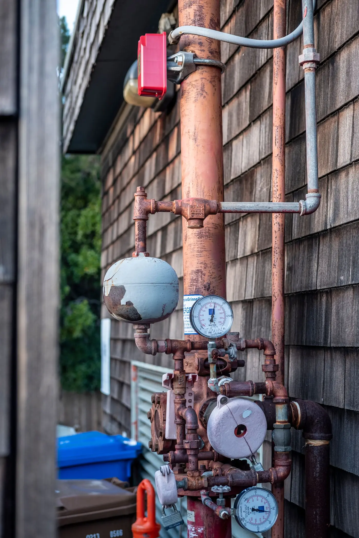 Weathered boiler pipework fitted with pressure gauges and shut-off valves