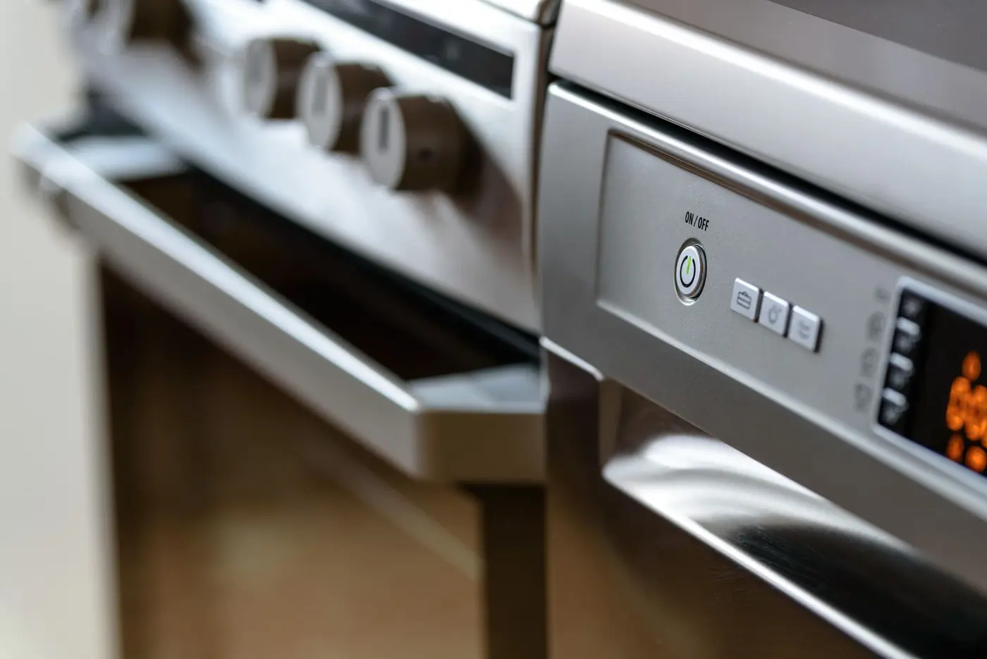 Stainless steel dishwasher installed under a kitchen counter