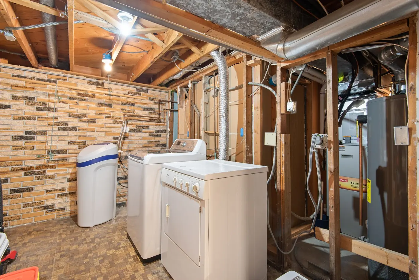 Gas furnace cabinet and sheet-metal ductwork in an unfinished basement utility room