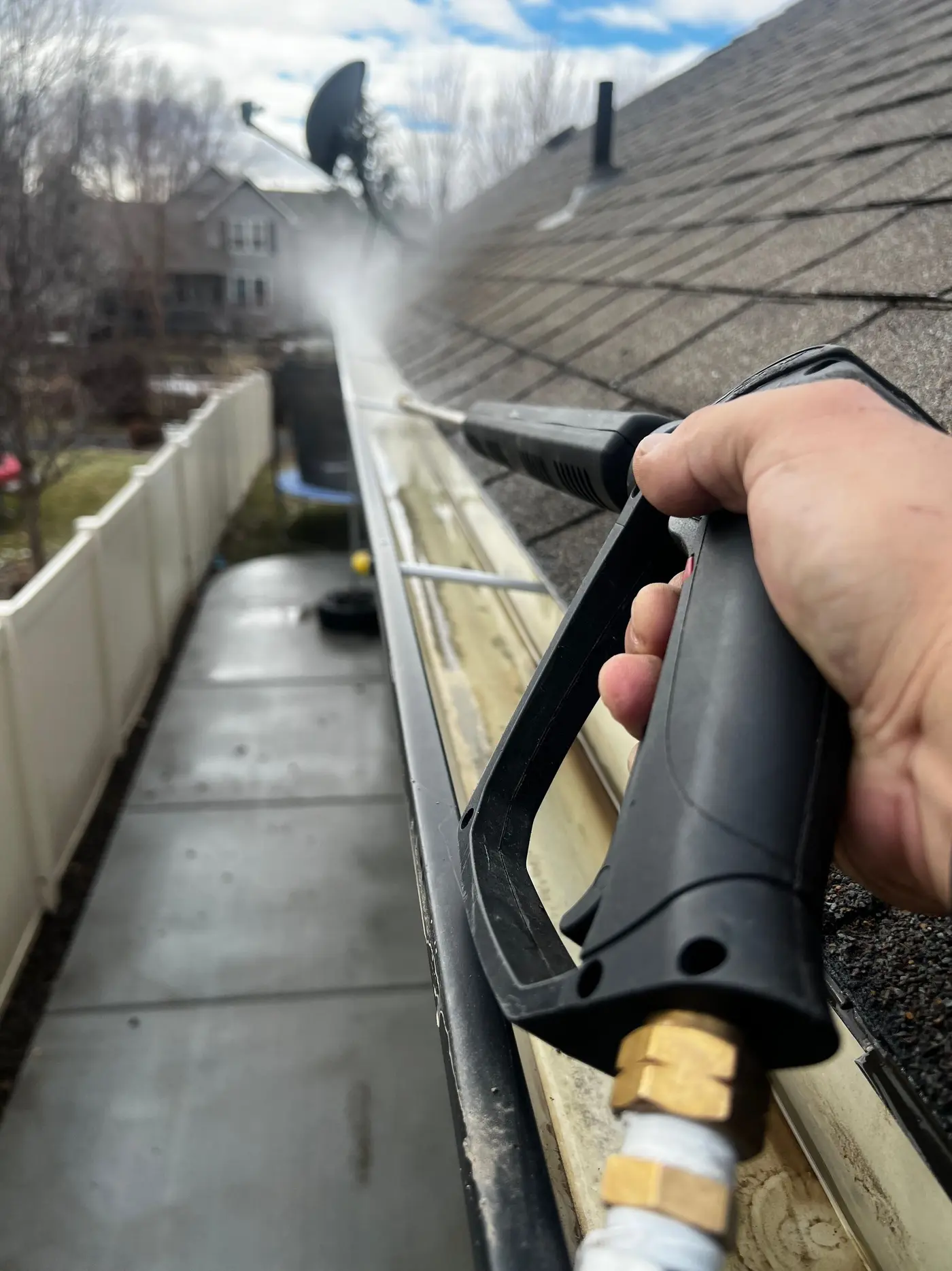 High-pressure hose flushing debris out of a residential drainage line