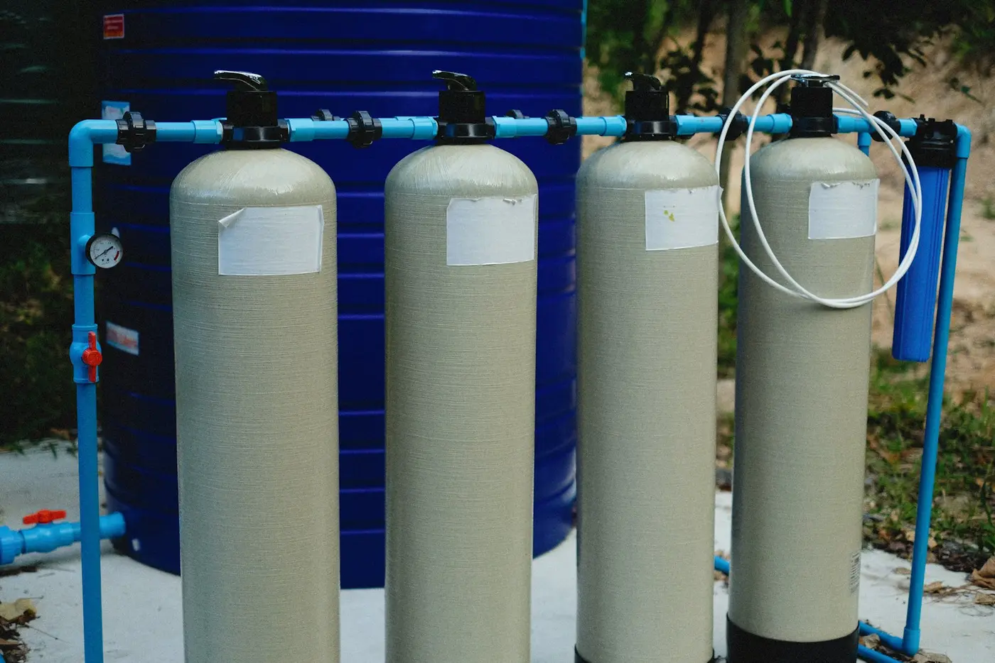 Two cylindrical water treatment tanks standing side by side